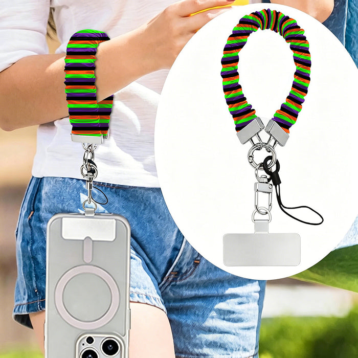 Main Witch Energy scrunchie phone wrist strap worn on the wrist and clipped at the hip, with a close-up of the striped fabric
