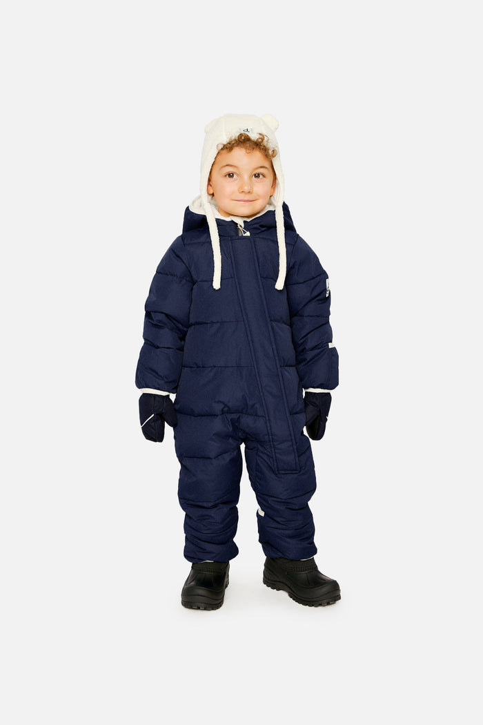 Child wearing the dark blue Deux par Deux Baby Cloud snowsuit, front view