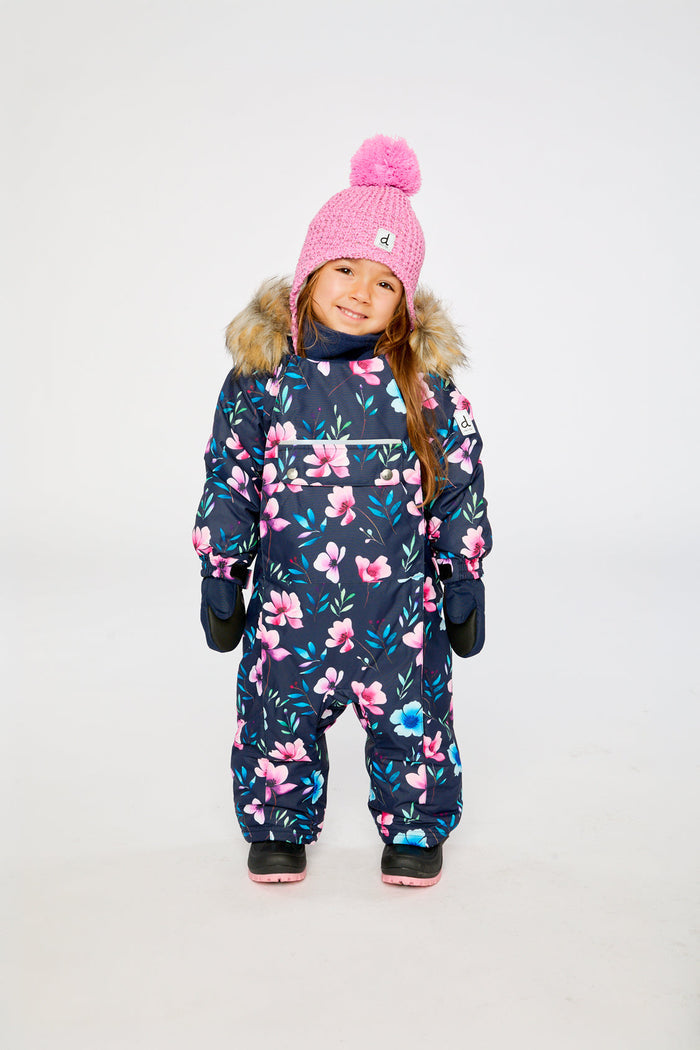 Child standing in the blue floral print Deux par Deux one-piece snowsuit, front view