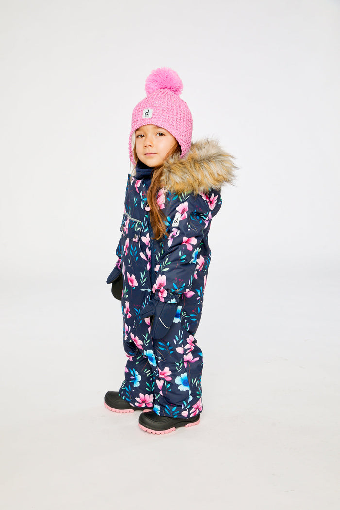 Side view of a child wearing the blue floral print car seat snowsuit