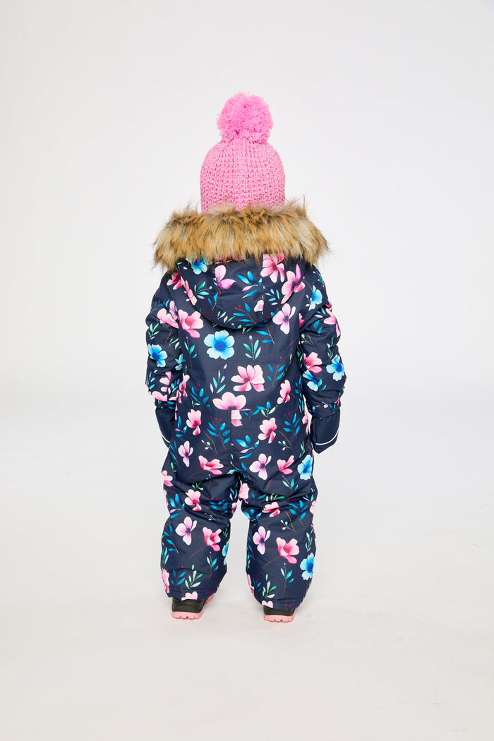 Back view of a child in the blue floral print snowsuit with faux-fur trimmed hood
