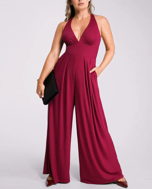 Model wearing deep V jumpsuit with built-in shaping support and flattering silhouette