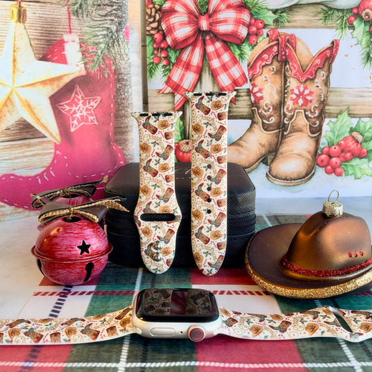 Boot Scootin' Christmas Apple Watch band shown on an Apple Watch and as two straps on a black jewelry box, cowboy boots and hats on cream