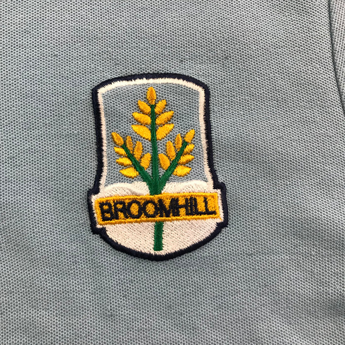 Second-hand Broomhill Primary unisex light blue polo shirt, flat lay view with embroidered school badge.