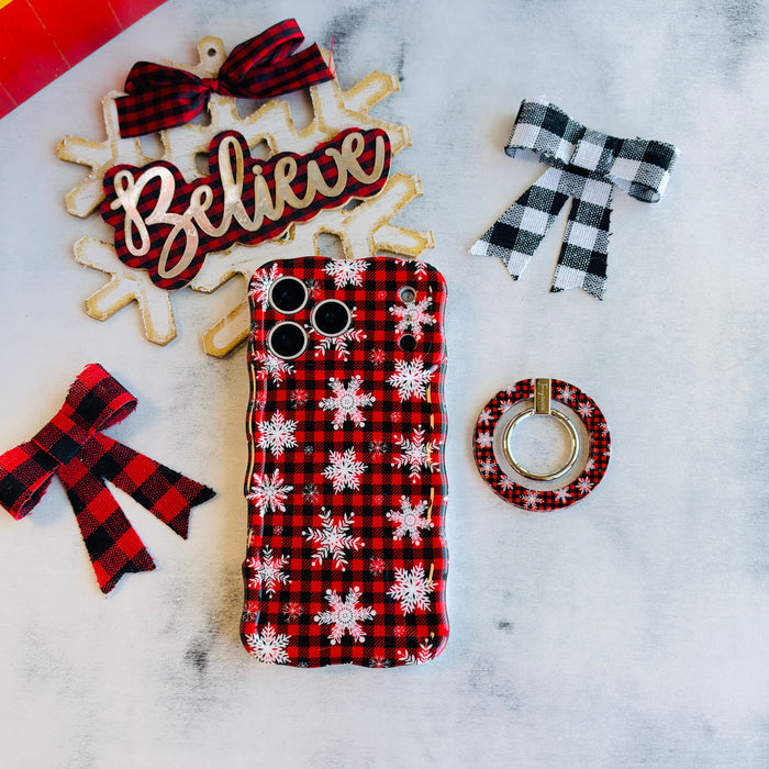 Buffalo Plaid Snowflake MagSafe grip ring beside the matching iPhone case, with a Believe sign and buffalo check bows