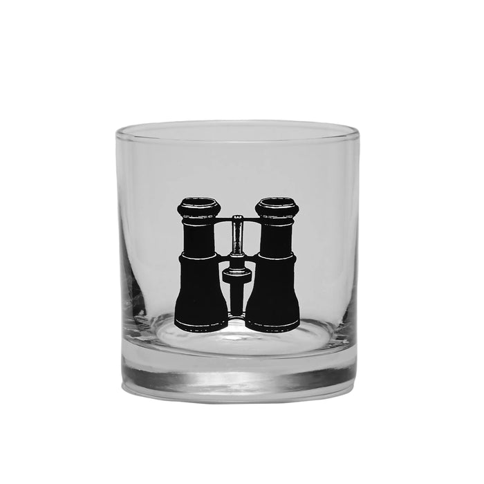 A clear cocktail glass with a matte black finish, featuring a silhouette of a state, possibly New York, on the mainland part of the glass.