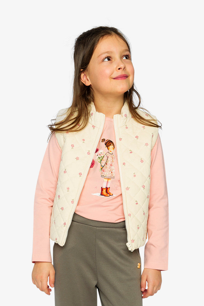 Lookbook view of a child in the Deux par Deux beige floral quilted vest