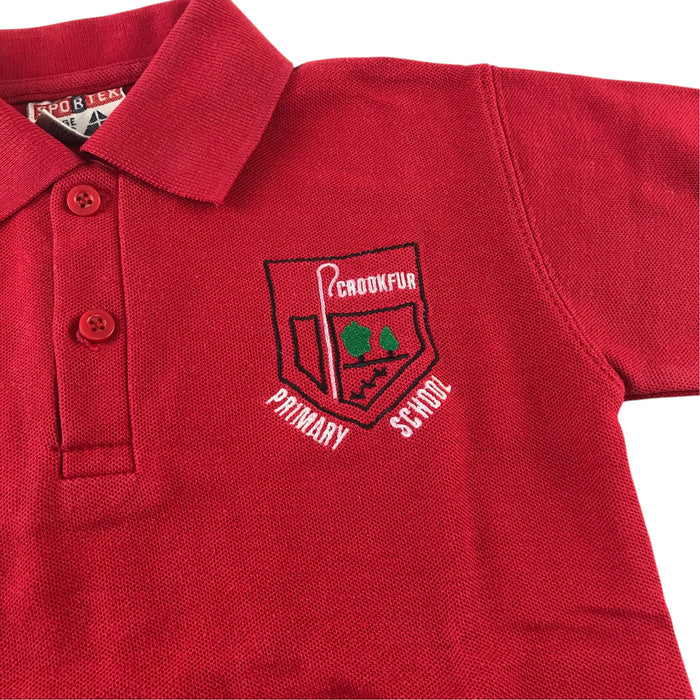 Second-hand Crookfur Primary red polo shirt, flat lay view with embroidered school badge.