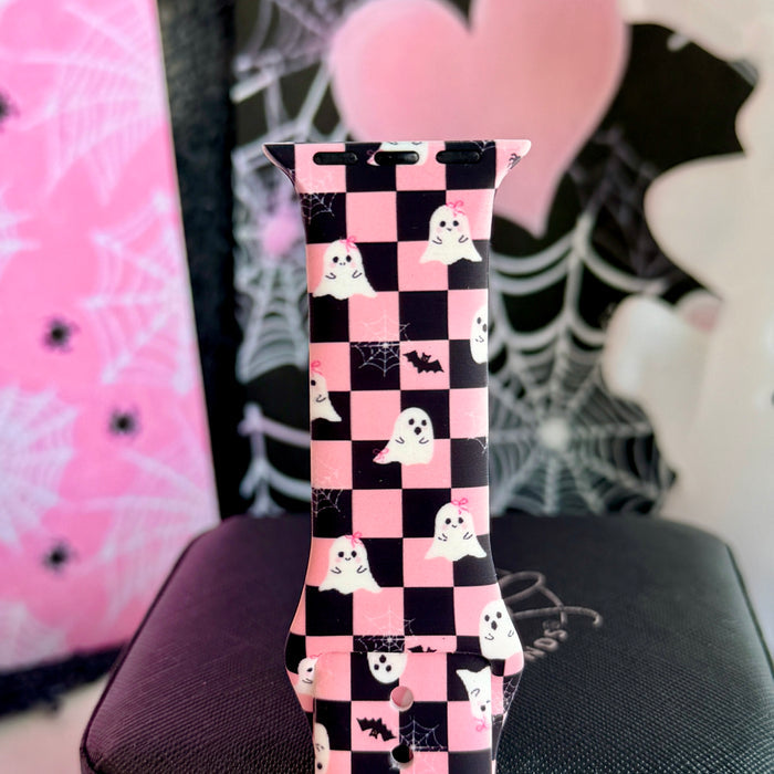Close view of the Hey Boo, Looking Cute Apple Watch band showing the white ghosts and small black bats across the pink and black checkerboard.