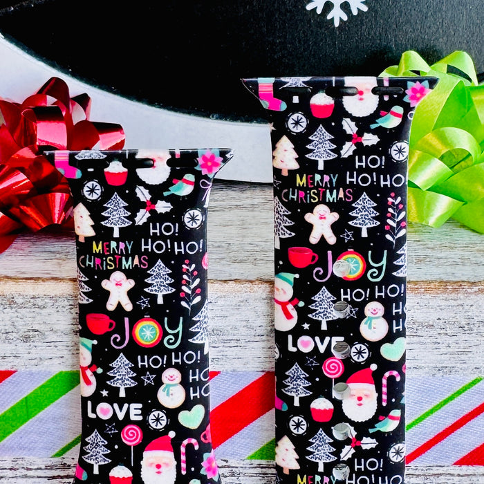 Close-up of the Jolly Wrist-mas Apple Watch band straps with red and green bows behind