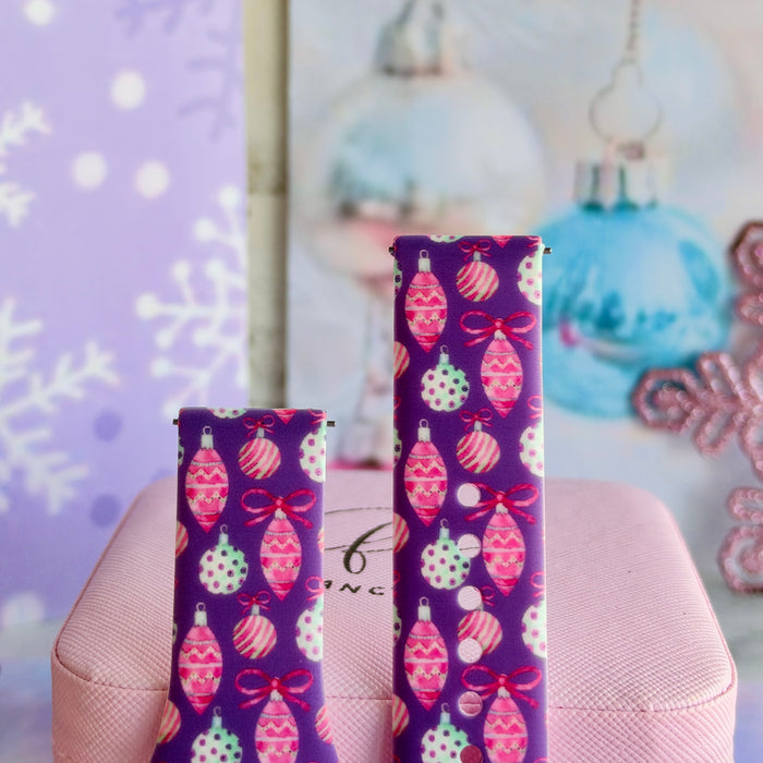Close-up of both Just One More Ornament Samsung Galaxy Watch band straps with pink and aqua ornaments on plum
