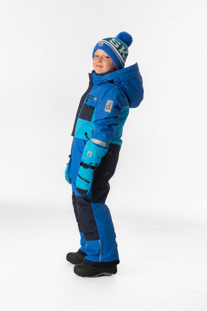Child wearing the light and dark blue Deux par Deux PLAY one-piece snowsuit, side view
