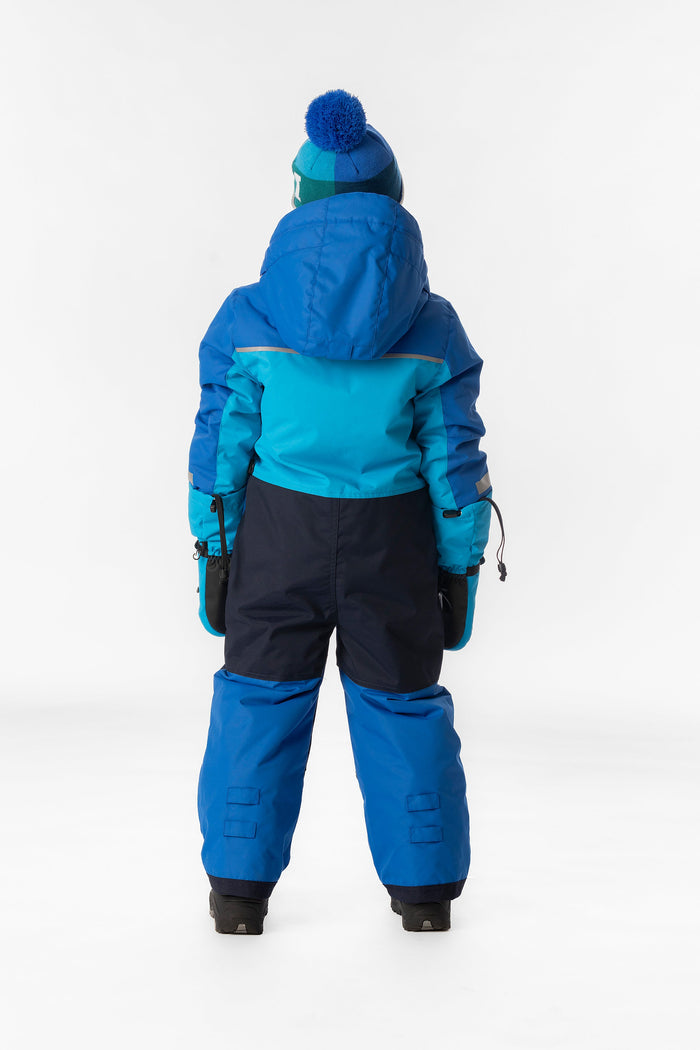 Child wearing the light and dark blue Deux par Deux PLAY one-piece snowsuit, back view