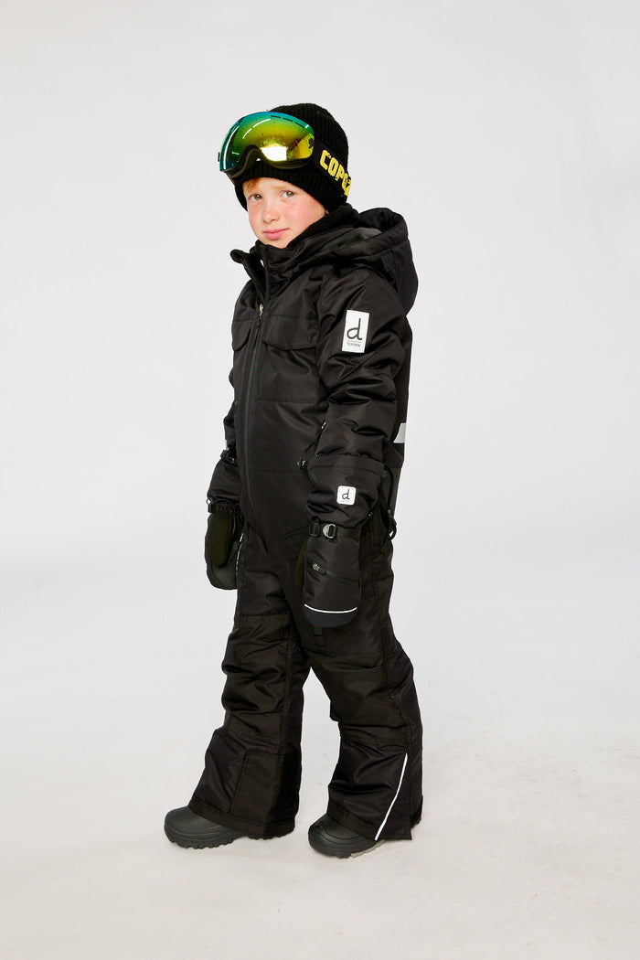 Child wearing the black Deux par Deux TEKNIK one-piece snowsuit, side view