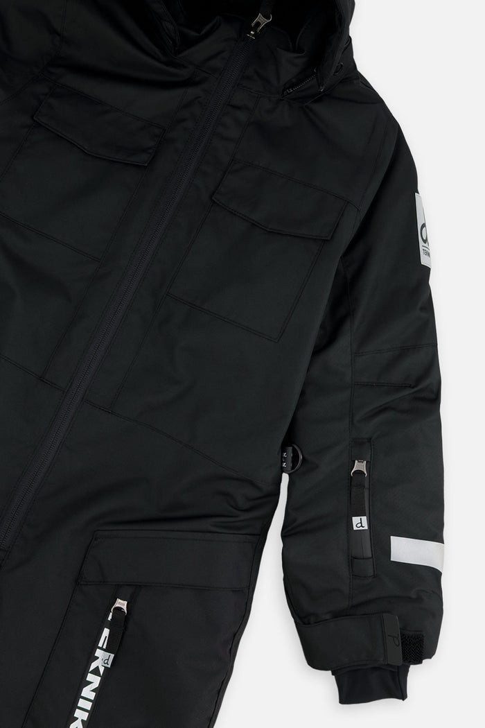 Close-up of the chest pockets, sleeve zip pocket and logo patch on the black TEKNIK snowsuit