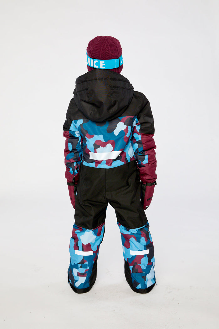 Child wearing the blue and red camouflage Deux par Deux TEKNIK one-piece snowsuit, back view