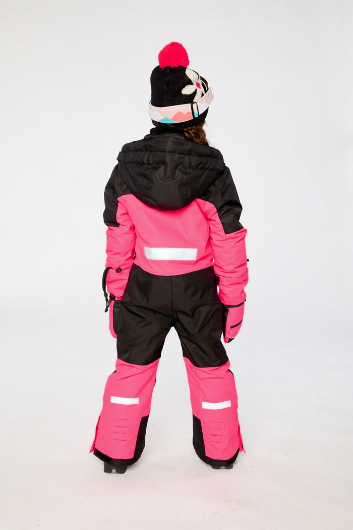 Child wearing the bright pink Deux par Deux TEKNIK one-piece snowsuit, back view