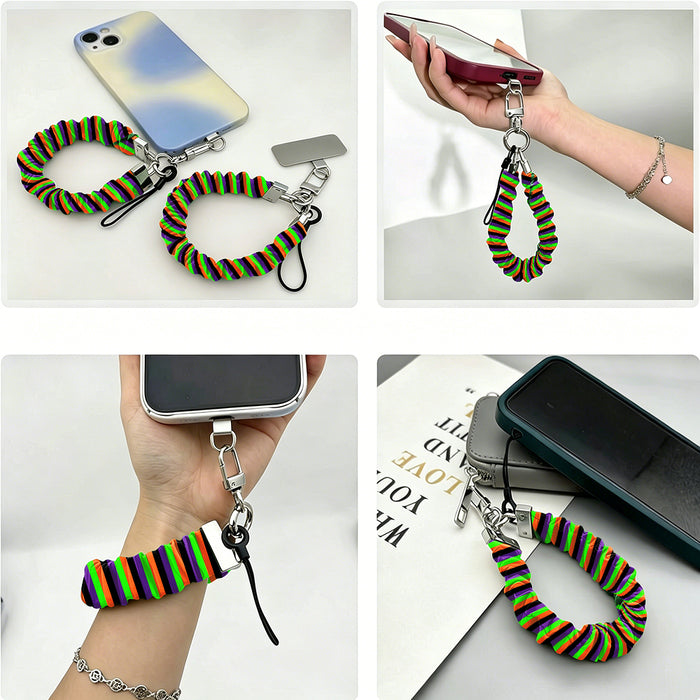Four views of the Main Witch Energy scrunchie phone wrist strap attached to a phone, worn on a wrist, and resting on a desk.