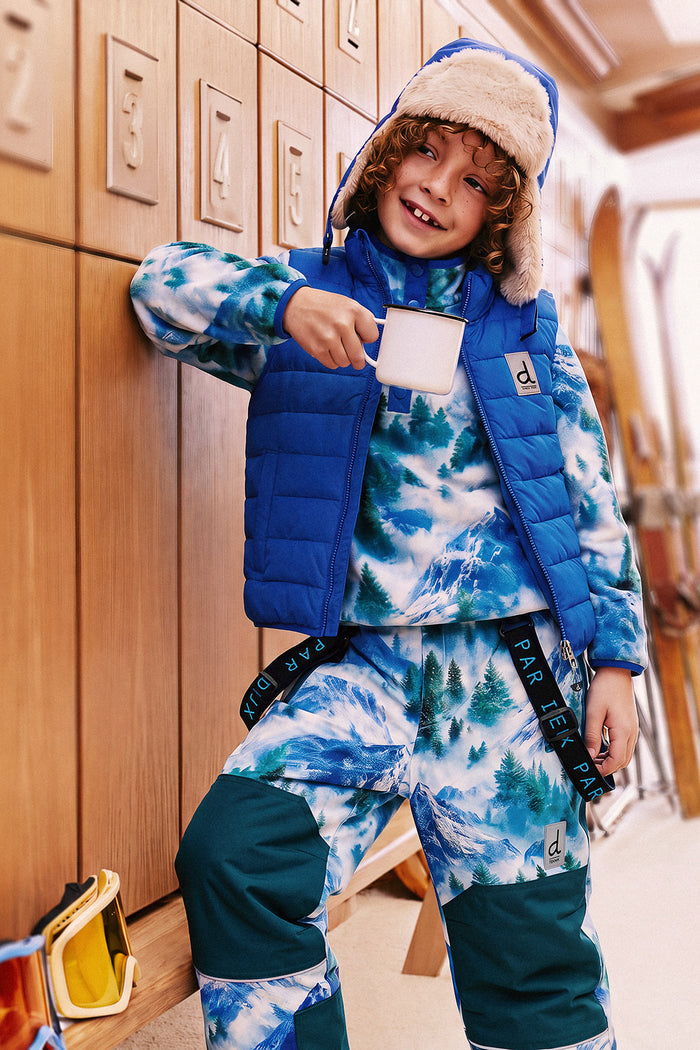 Deux par Deux boys' plush fleece snap-front pullover in blue mountain print – lifestyle photo, seated