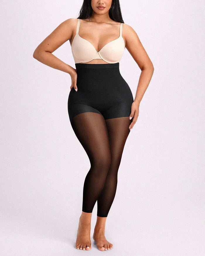 Model facing front in black shaping tights engineered with targeted midsection flattening and all-day breathable comfort