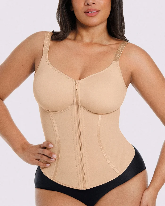 Fitted beige shaping corset top creating a defined waist silhouette