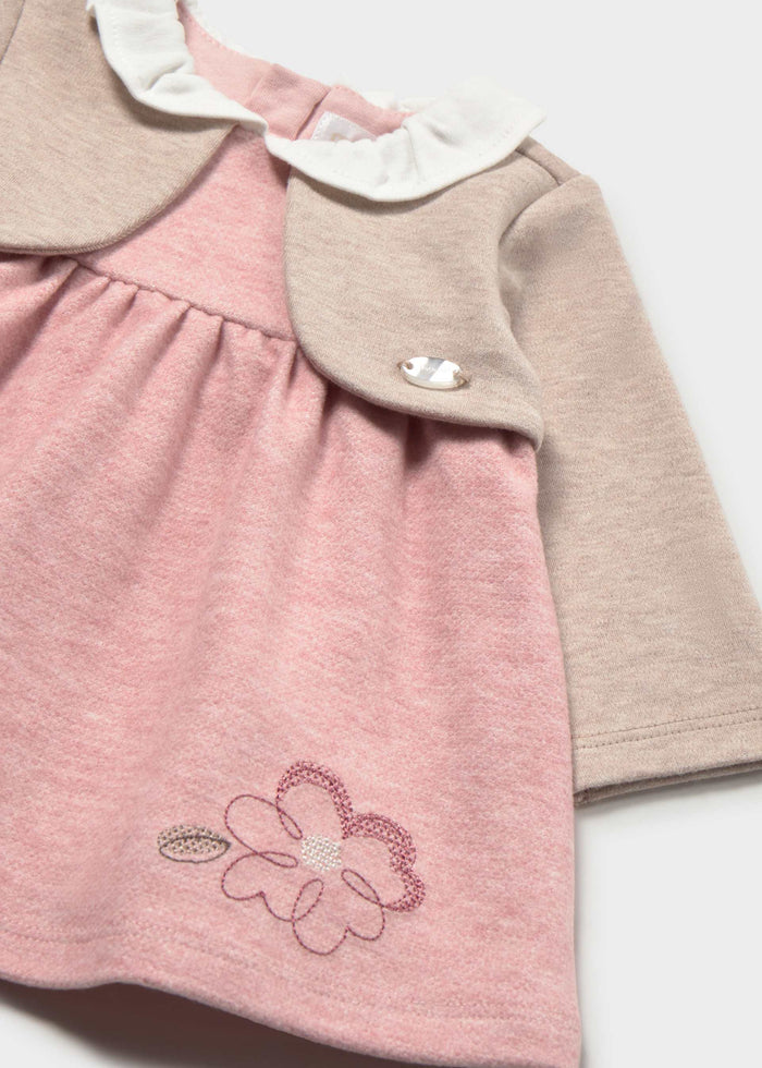 Close-up of the flower embroidery and ruffled collar on the Mayoral pink dress with cardigan