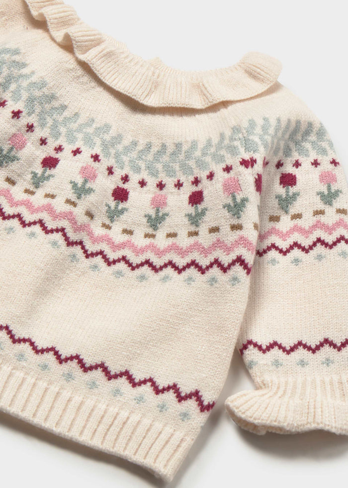 Close-up of the patterned knit, ruffled collar and cuff on the Mayoral baby sweater