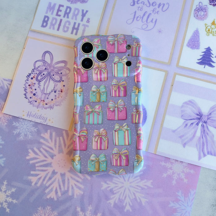 No Peeking, Darling iPhone case lying flat on lavender snowflake paper beside Merry & Bright and Tis the Season holiday cards