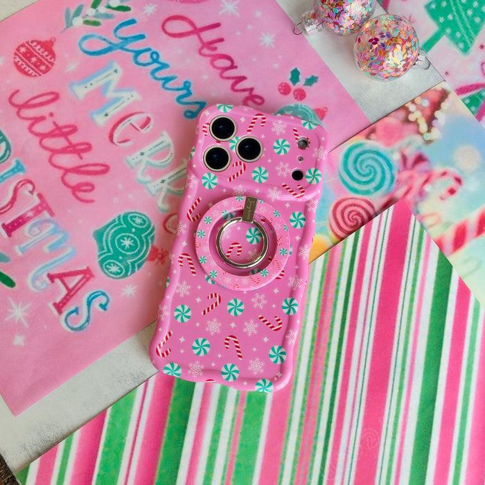 Peppermint Cutie Hold It Fancy MagSafe grip ring snapped onto the matching pink peppermint iPhone case, on candy stripe paper