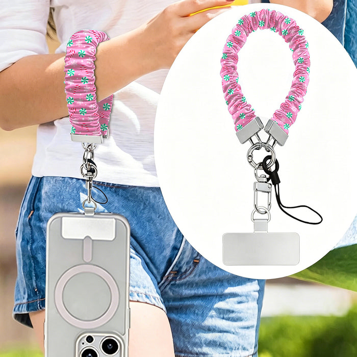 Peppermint Cutie scrunchie phone strap worn on the wrist with an iPhone hanging from it, plus close-up of the strap and phone tab
