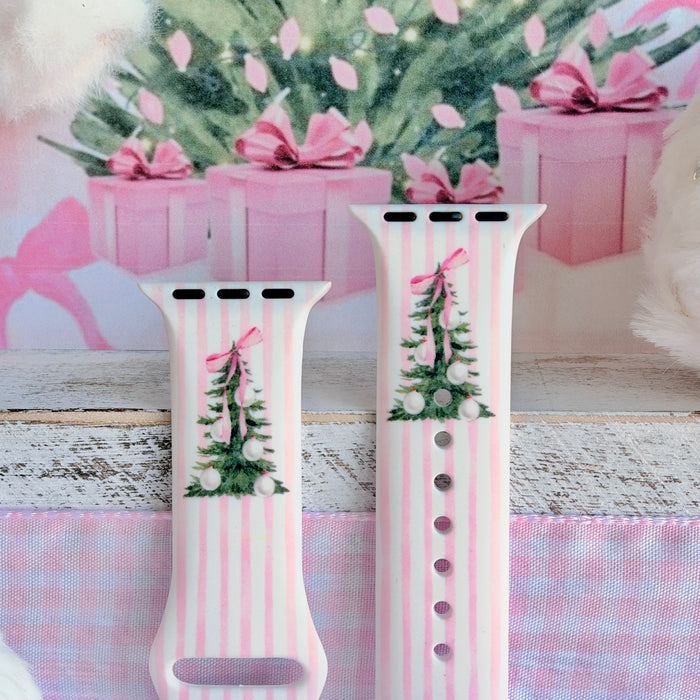 Both straps of the Pretty in PinkMas silicone Apple Watch band standing up, each with a watercolor Christmas tree and pink bow