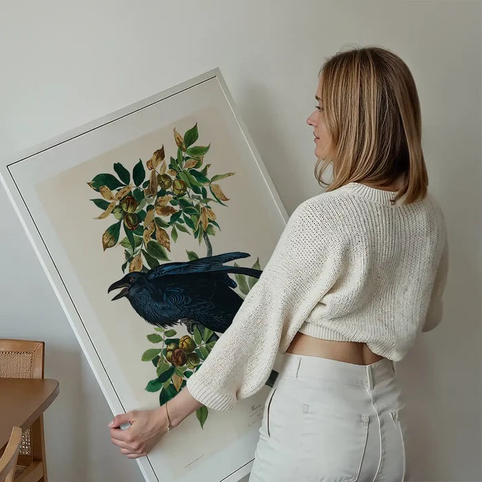 Raven Vintage Bird Print held up against a living room wall