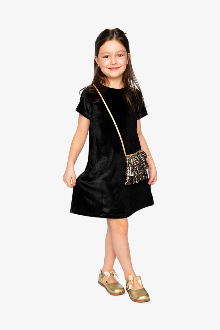 Child wearing the black and gold sleeveless velour dress by Deux par Deux