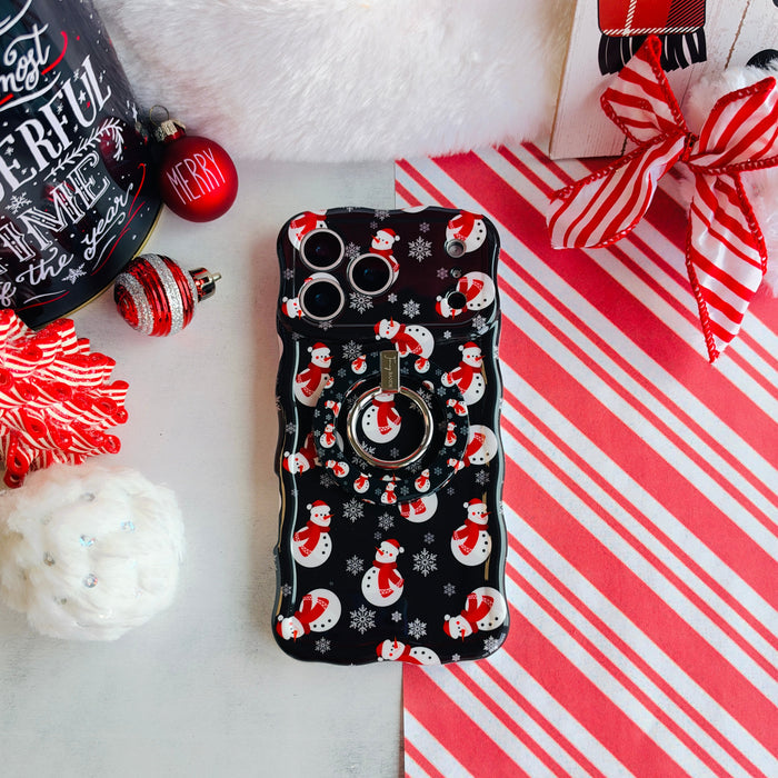 Snowman Hold It Fancy MagSafe grip ring attached to the matching snowman iPhone case, on candy cane stripes with a Santa hat and ornaments