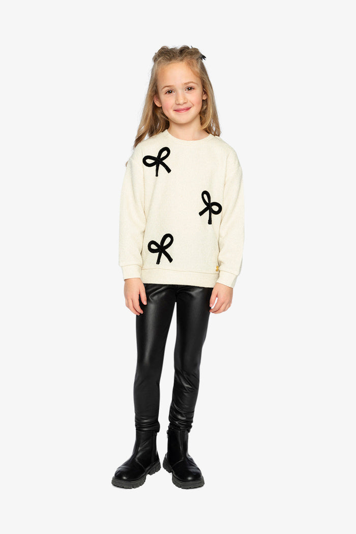 Deux par Deux beige and black bow sweatshirt shown in a full outfit