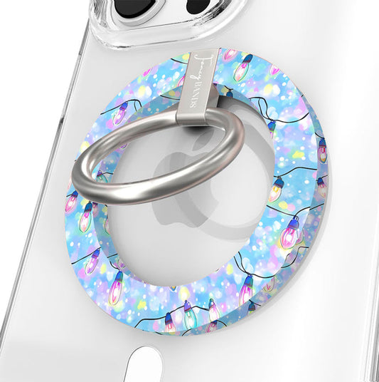 Close-up of the Twinkle All The Way MagSafe grip ring with pastel Christmas lights on blue and a brushed silver ring on a clear iPhone case