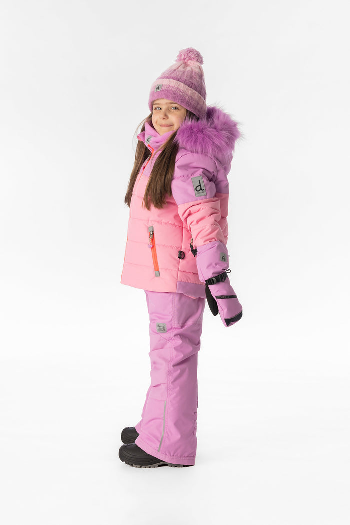 Child wearing the pinkish violet and pink Deux par Deux PLAY snowsuit, side view