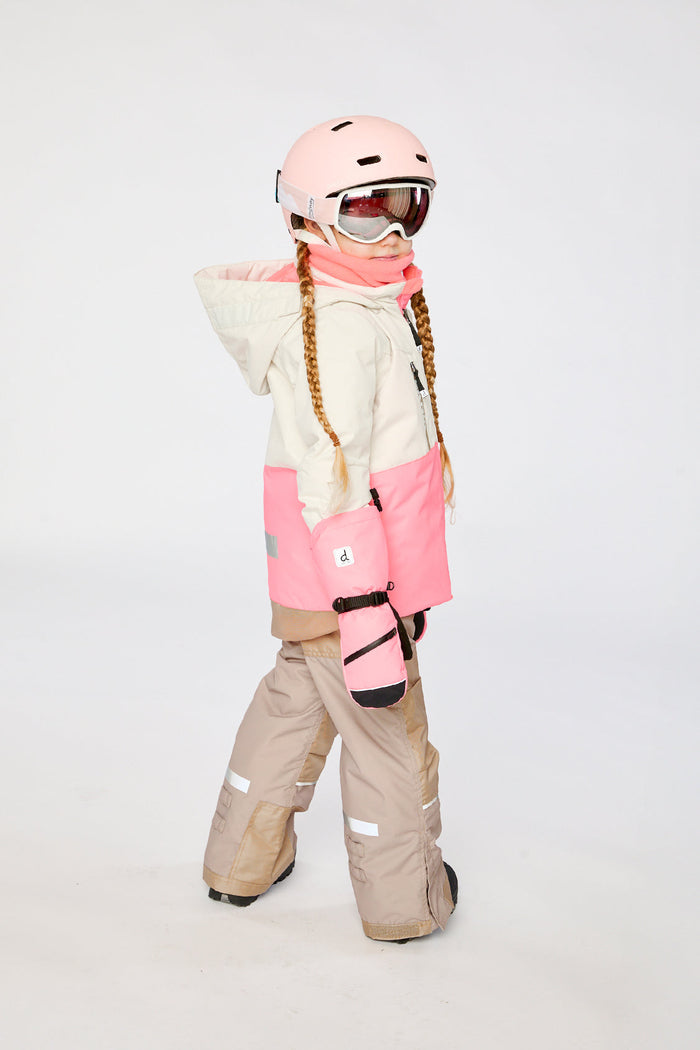Child in the off-white and pink Deux par Deux TEKNIK snowsuit, side view
