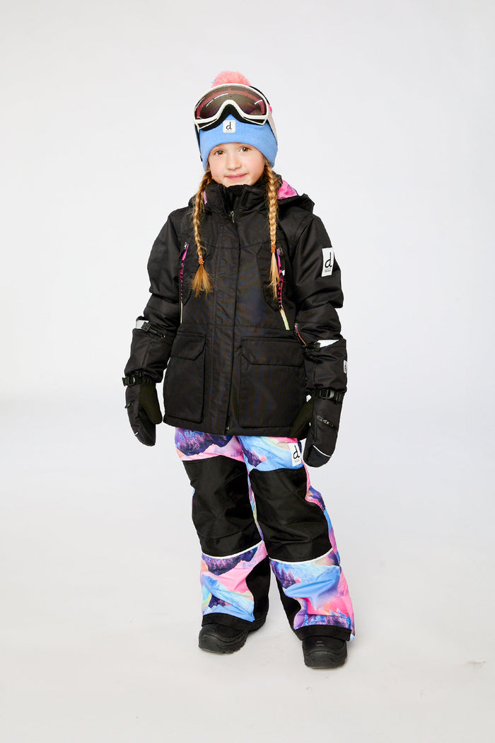 Deux par Deux girls' Teknik snowsuit, black jacket and pink-blue mountain print pants – worn by a child model, full length