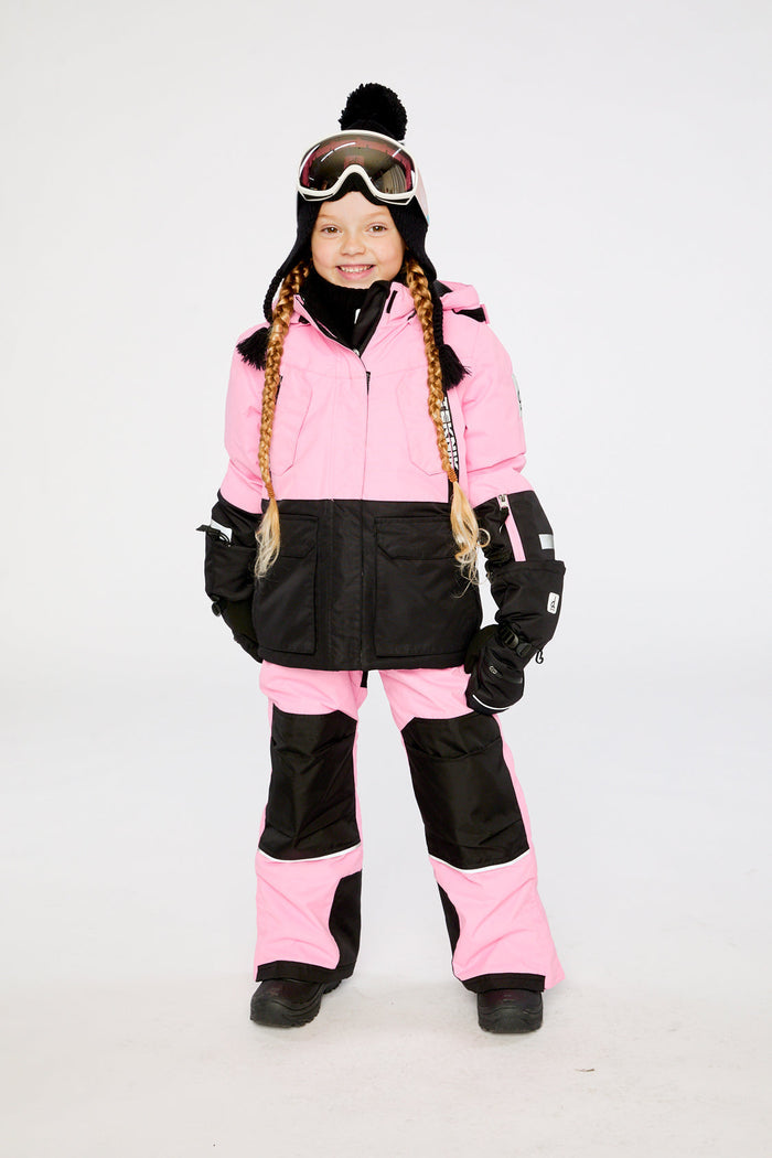 Child wearing the pink and black Deux par Deux TEKNIK two-piece snowsuit, front view