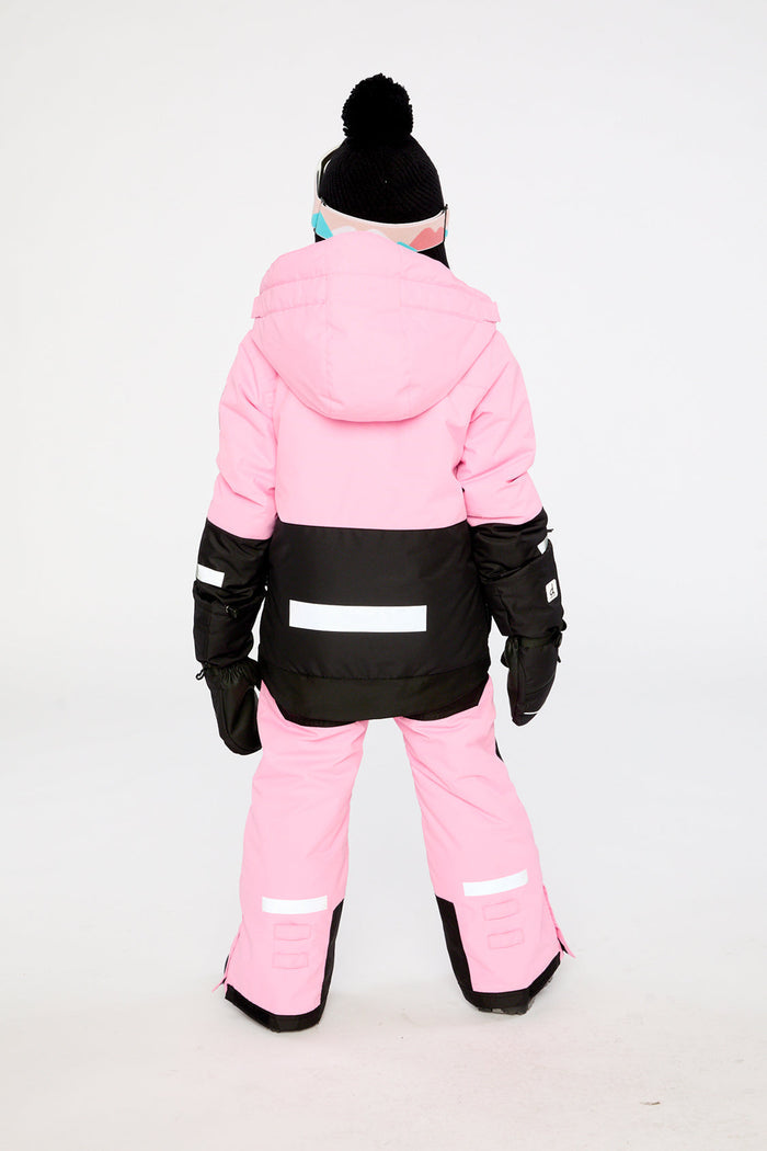 Child wearing the pink and black Deux par Deux TEKNIK two-piece snowsuit, back view