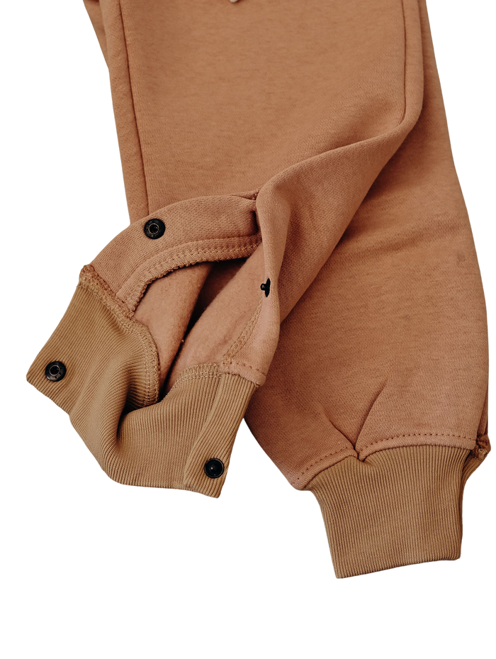 Pink jogger ankle cuffs with black press studs.