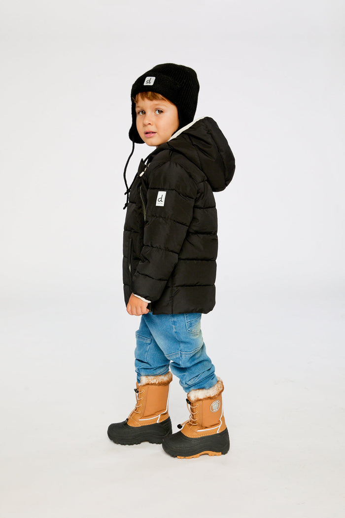 Child wearing the Deux par Deux black car seat winter jacket, side view